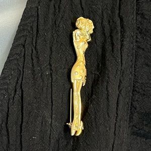 Long & thin Vintage metal Brooch by CAJC. Stylish woman wearing polka dot dress